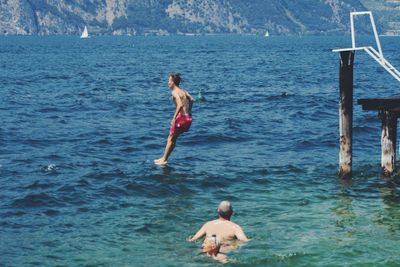 People jumping in sea