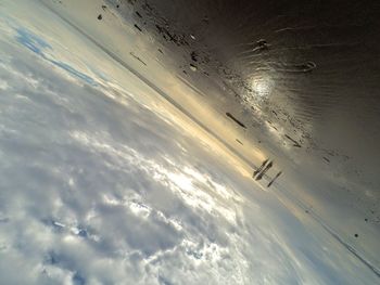 Airplane flying over sea against sky