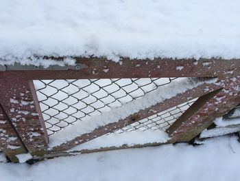 High angle view of fence on snow covered field