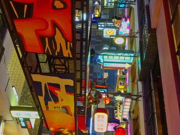 Low angle view of illuminated text on building at night