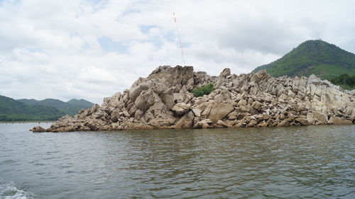 Scenic view of sea and mountains against sky