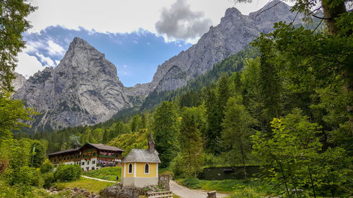 Scenic view of mountains and trees against sky