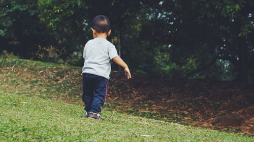 Full length of boy standing on field