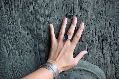 Cropped hand of woman on wooden door