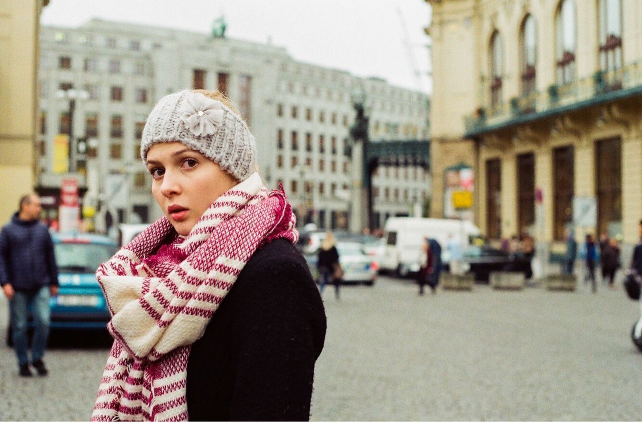 WOMAN STANDING IN CITY