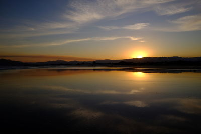 Scenic view of beach against sky during sunset