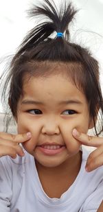 Close-up of girl touching cheeks