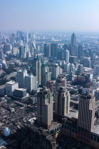 High angle view of modern buildings in city against sky