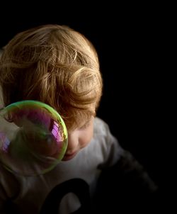 Portrait of a girl holding black background