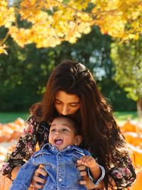 Portrait of happy mother and daughter in park