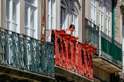 Full length of man painting on building wall