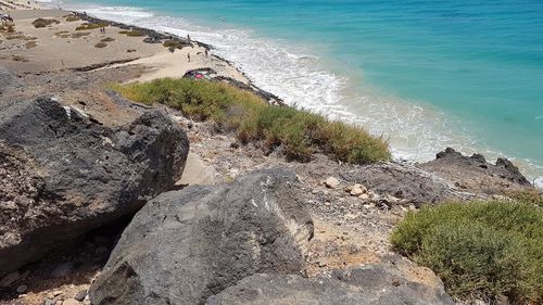 High angle view of rocks by sea