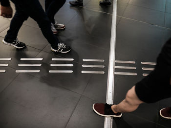 Low section of man walking on street