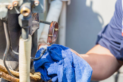 Close-up of man working with rope