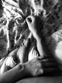 Low section of woman lying on bed