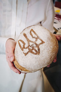 Midsection of person holding bread