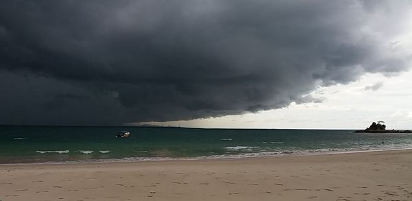 Scenic view of sea against cloudy sky