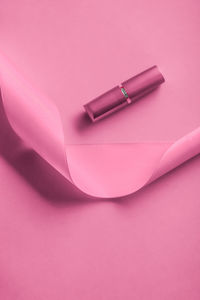 High angle view of lipstick on red background