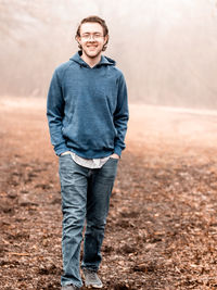 Portrait of a smiling young man standing on land