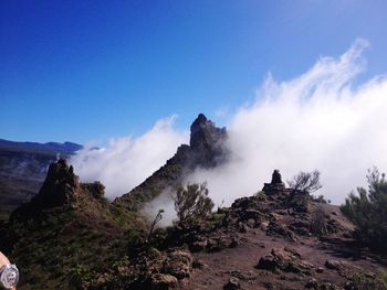 Scenic view of mountains against cloudy sky