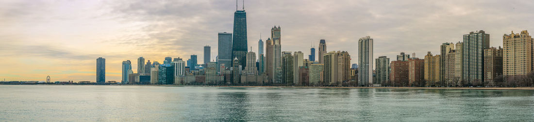 Panoramic view of modern buildings against sky during sunset