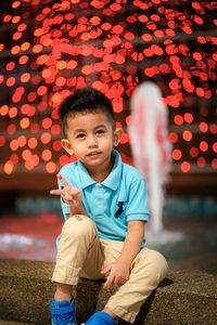 Portrait of boy sitting outdoors