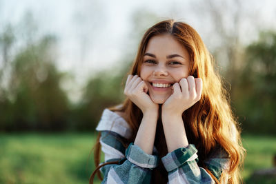 Portrait of young woman standing outdoors