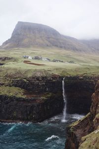 Scenic view of waterfall against sky