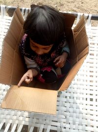 High angle view of boy sitting on steps