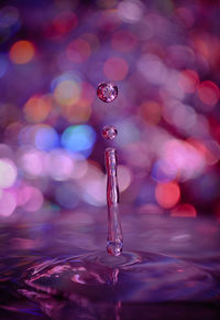 Close-up of drop falling on water