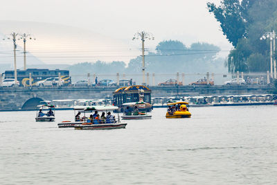 Boats in river with buildings in background