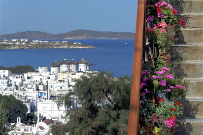 Scenic view of sea by buildings against sky