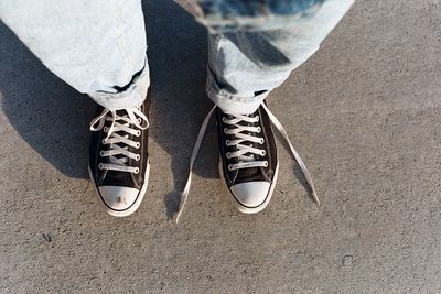 Low section of man standing on shoes