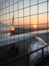 Digital composite image of window against sky during sunset