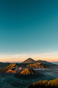 Scenic view of mountains against sky at dusk