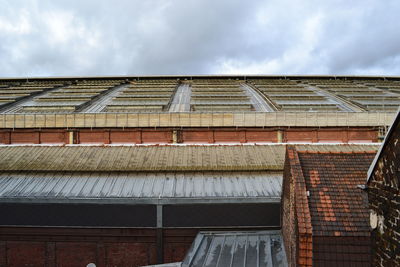 Low angle view of building against cloudy sky