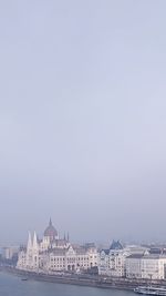 Buildings in city against clear sky