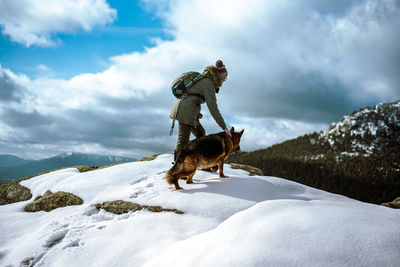 Dog on snow covered landscape