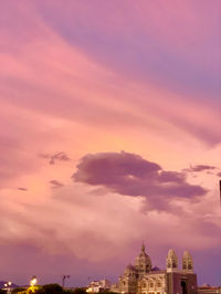 Low angle view of buildings against sky during sunset