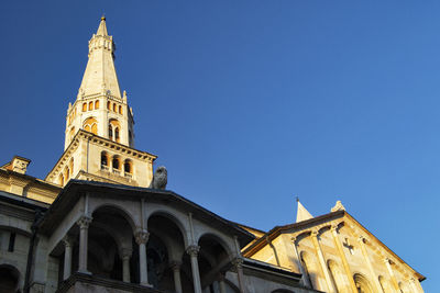 Low angle view of historic building against clear blue sky