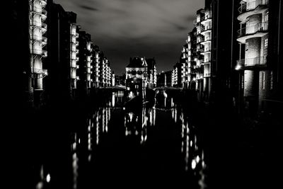 Panoramic shot of illuminated buildings against sky at night