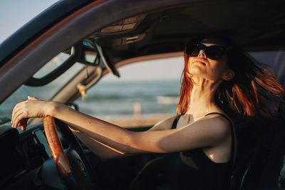 Young woman sitting in car