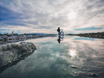 Rear view of man walking on snow