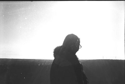 Side view of woman looking against clear sky