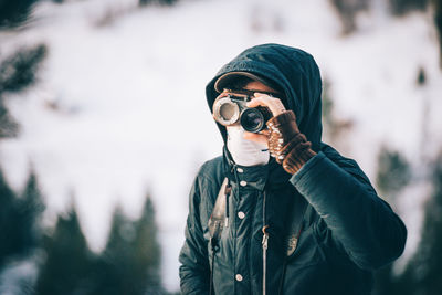 Reflection of man photographing