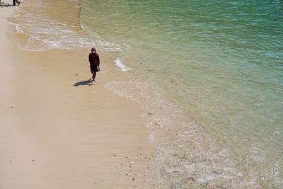 High angle view of man walking on beach