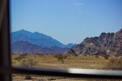 Scenic view of mountains against clear blue sky