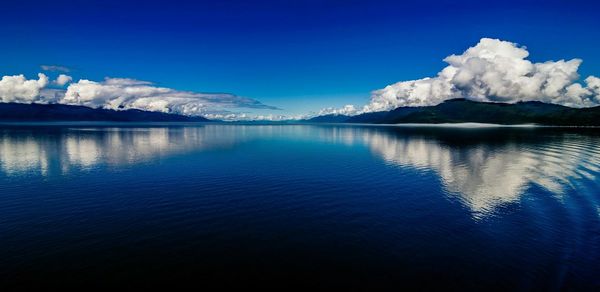 Scenic view of lake and mountains against sky