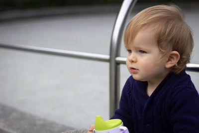 Portrait of cute boy holding camera