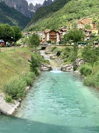 Scenic view of river amidst buildings